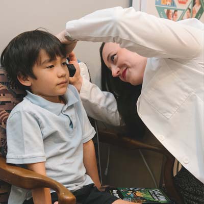 Checking a child's ear for Auditory Processing Disorder (APD).